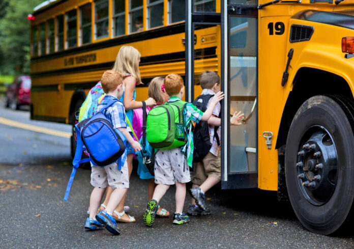 A,Group,Of,Young,Children,Getting,On,The,Schoolbus