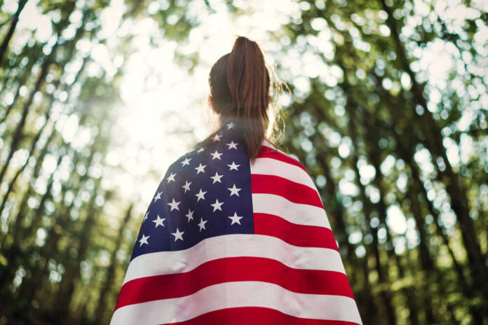 Child,Teenager,Girl,At,Nature,Background,With,An,American,Flag