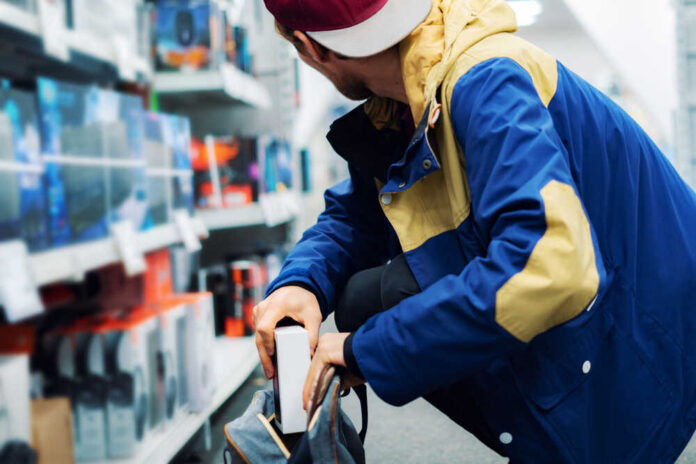 Close,Up,Consumer,Thief’s,Hands,Putting,The,New,Gadget,In