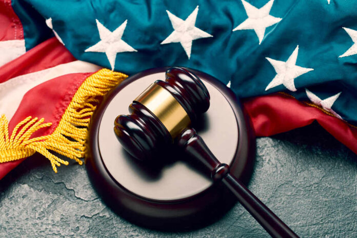 Judge's,Wooden,Gavel,On,Background,Of,American,Flag,On,Black