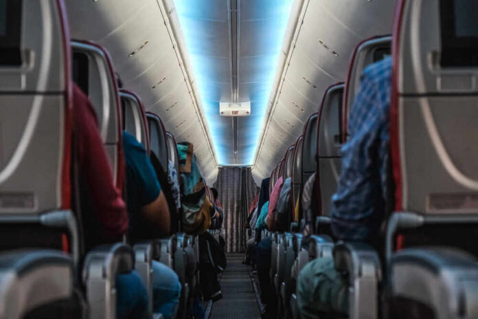 Passenger,Sitting,In,Plane,,Interior,Of,Airplane,In,Economy,Class.