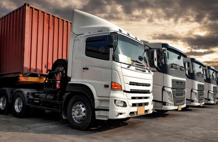 Semi,Trailer,Trucks,The,Parking,Lot,At,The,Sunset,Sky.