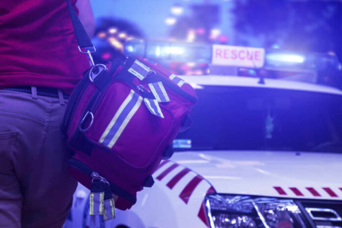 Back,View,Of,Rescue,Service,Team,Member,Holding,A,Bag