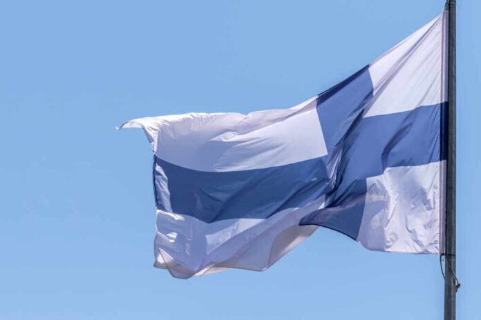 Finnish,National,Flag,Waving,On,Blue,Sky,Background.,Republic,Of
