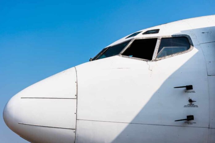Close,Up,Of,Cockpit,White,Large,Passenger,Airplane,With,Blue