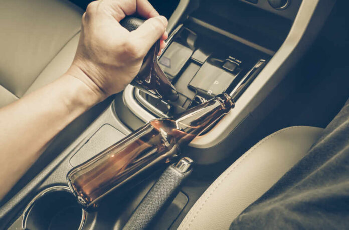 A,Driver,Holding,Alcoholic,Bottle,While,Driving,/,Drunk,Driving