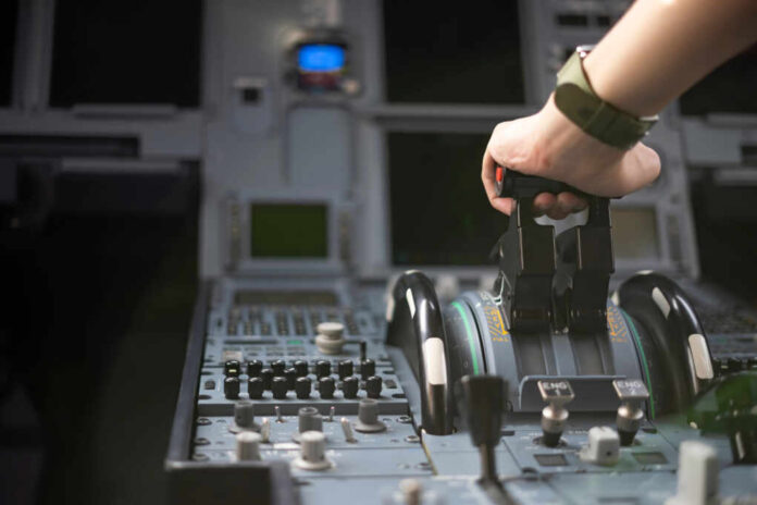 Cropped,Hands,Of,Pilot,Flying,A,Commercial,Airplane,,Cockpit,View