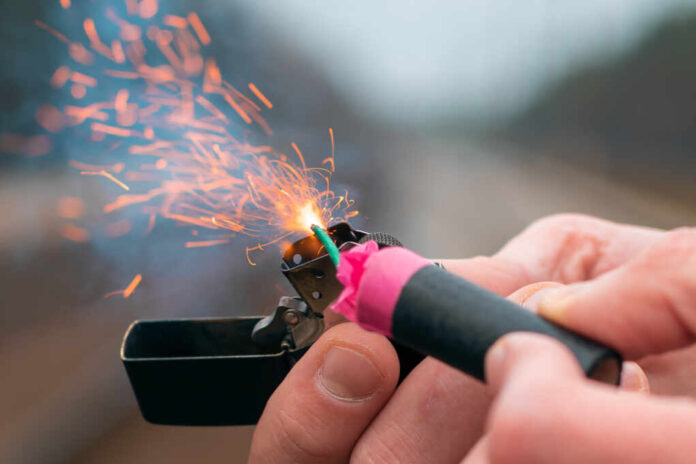 The,Firecracker,In,A,Hand.,Man,Holding,A,Burning,Petard