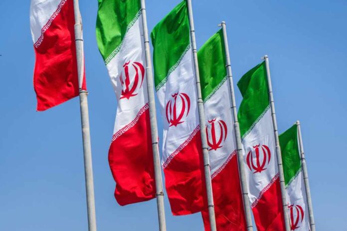 Group,Of,Iran,Flags,Against,Blue,Sunny,Sky,Background