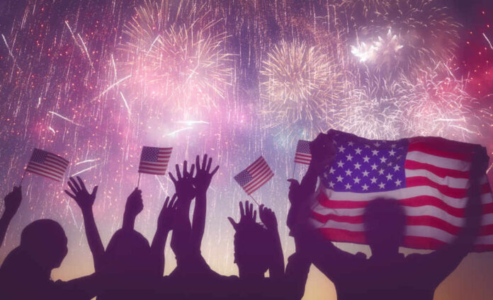 Patriotic,Holiday.,Silhouettes,Of,People,Holding,The,Flag,Of,Usa.