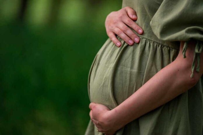 Caucasian,Young,Pregnant,Woman,Tummy,Belly,Summer,Green,Dress,Touching