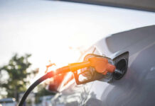 California’s Pump Pain: What’s the True Cause? A fuel nozzle inserted into a cars gas tank during sunset