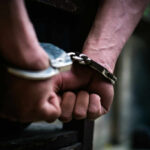 Serial Trespasser Turns NYC Building Into Terror Zone Close-up of hands in handcuffs, indicating an arrest