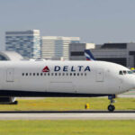 Delta Airlines airplane taxiing on the runway at an airport