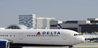 Delta Airlines airplane taxiing on the runway at an airport