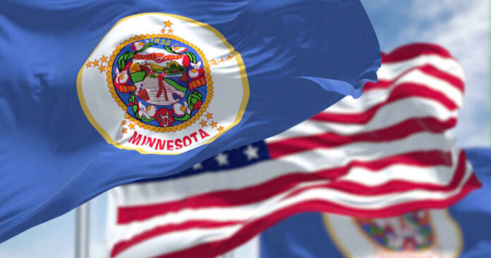 Minnesota state flag in front of American flags