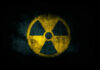 Radiation symbol on a textured dark background