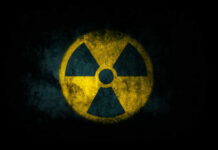 Radiation symbol on a textured dark background
