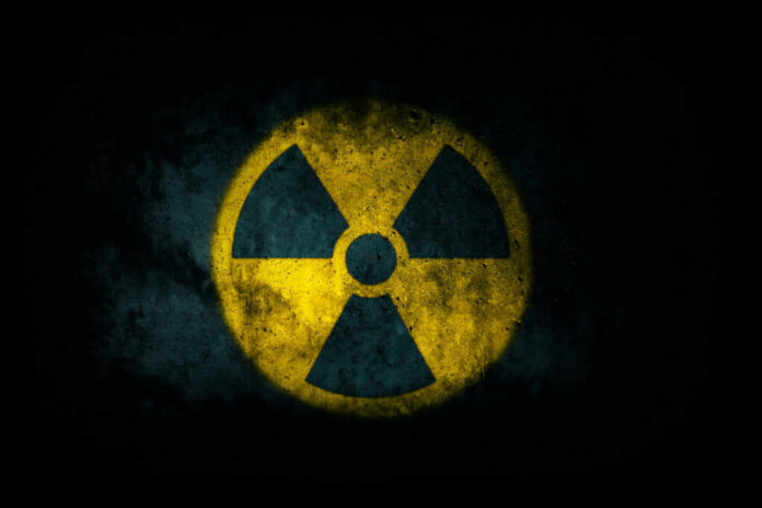 Radiation symbol on a textured dark background