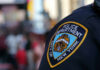 Close-up of a New York City police badge on an officers uniform