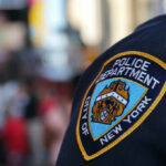 Close-up of a New York City police badge on an officers uniform