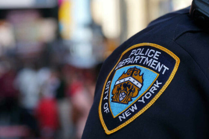 Close-up of a New York City police badge on an officers uniform