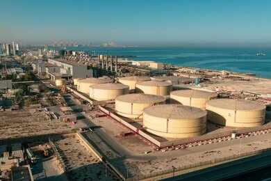 shutterstock_1859033734.jpg Aerial view of large oil storage tanks near a coastal area