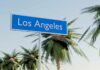 Sign indicating Los Angeles with palm trees in the background