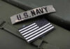 U.S. Navy patch and American flag on a green surface