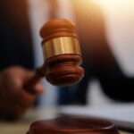 False Murder Claim Lands TikToker in Hot Water A judge's gavel being raised in a courtroom setting