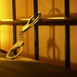 Close-up of handcuffs attached to a bed frame