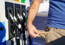 Person at a gas station showing empty pockets