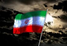 Iranian Leadership In Crisis: Top Figures Eliminated Iranian flag waving against a dark, cloudy sky