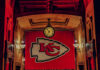 Swift-Kelce Wedding Drama: Chiefs GM Squirming Large Kansas City Chiefs banner with a clock in a historic indoor setting