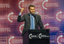 Speaker at a podium delivering a political speech