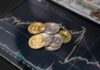 Various cryptocurrency coins on a digital trading chart