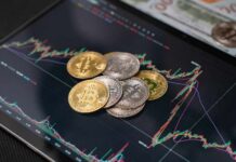 Various cryptocurrency coins on a digital trading chart