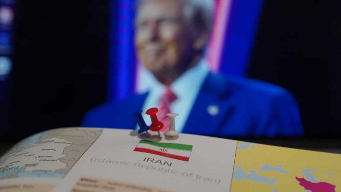 Map of Iran with push pins and a blurred figure in the background