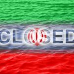 Hormuz Blockade SHOCKS Global Markets Graphic representation of the word 'CLOSED' overlaid on the Iranian flag with a water background