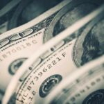 Millionaires Made Scooping Poop? Shocking Truth Close-up of folded hundred dollar bills