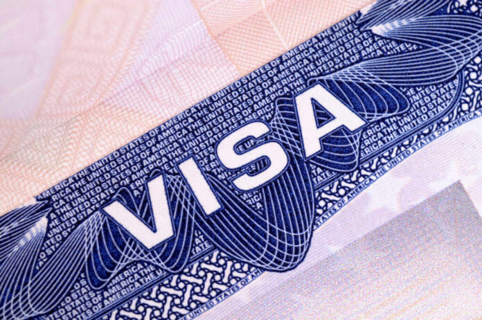 Close-up of a visa document showing the word VISA and intricate design elements