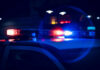 Close-up of police car lights flashing at night
