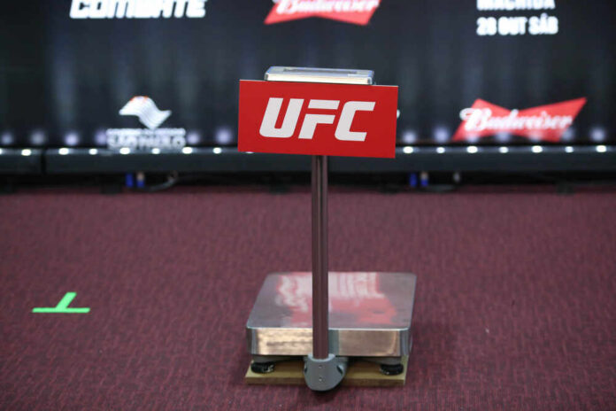 UFC weighing scale with a red sign in front