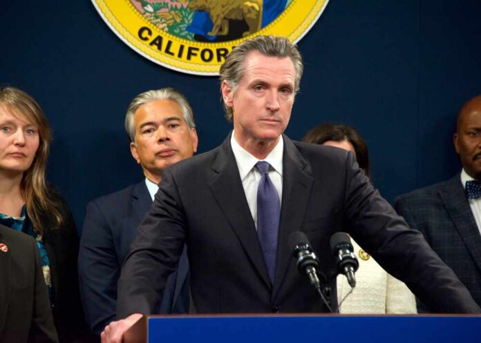 California officials at a press conference with a speaker at the podium