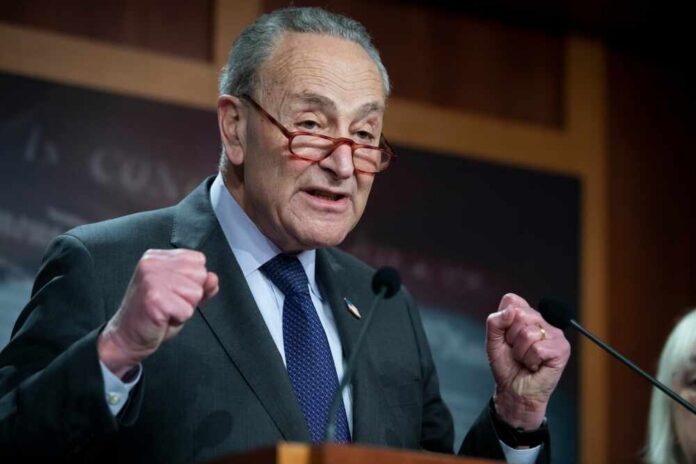 A senator passionately speaking at a press conference with raised fists