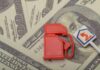 Red fuel pump toy next to hundred dollar bills