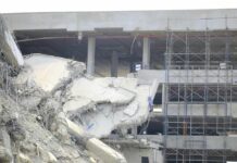 Damaged building structure with exposed debris and scaffolding