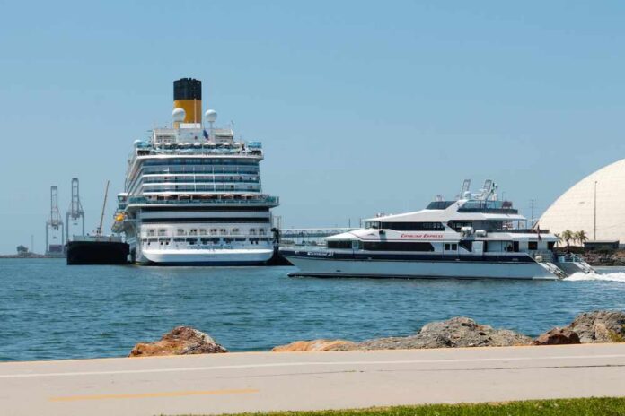 A large cruise ship and a ferry docked in a harbor