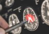 A hand pointing at a brain scan with highlighted areas
