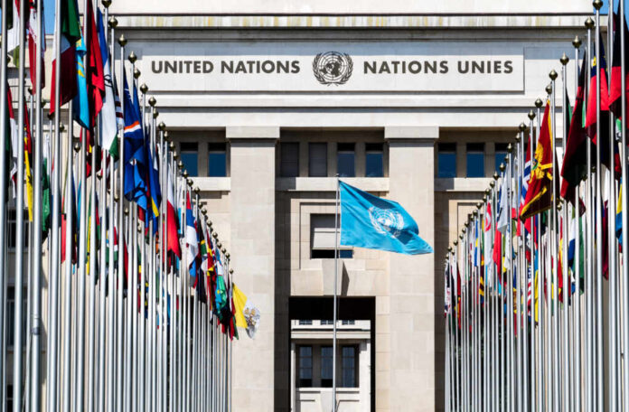 United Nations building with multiple international flags in front